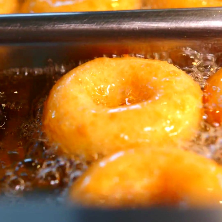 Doughnuts frying golden